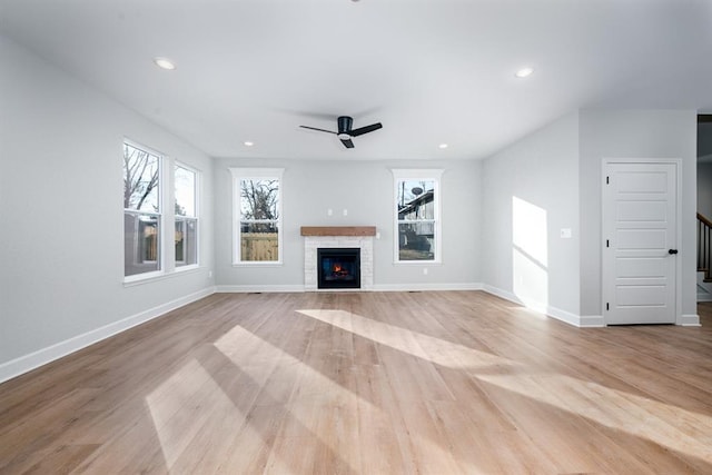 unfurnished living room with ceiling fan and light wood-type flooring