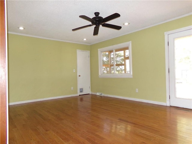 unfurnished room with ornamental molding, hardwood / wood-style floors, and ceiling fan