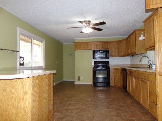 kitchen with a textured ceiling, black appliances, sink, and ornamental molding