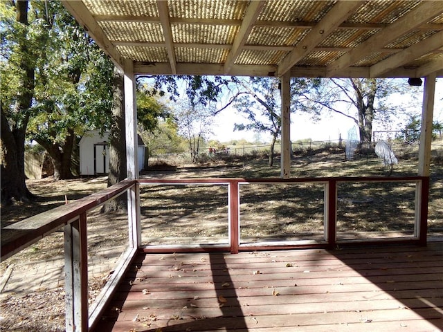 wooden deck featuring a storage shed