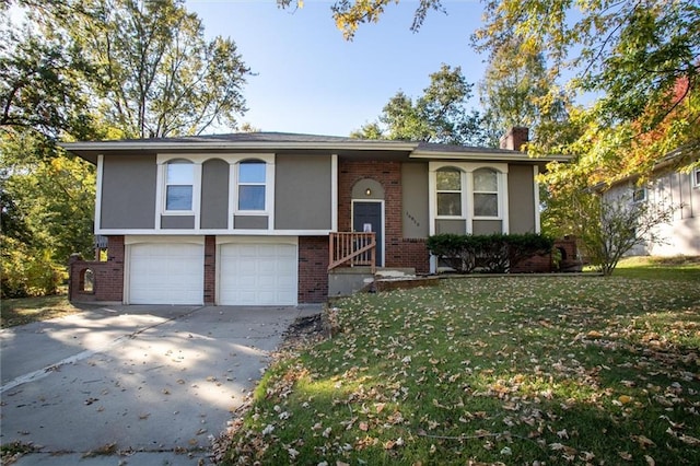 split foyer home with a garage and a front lawn