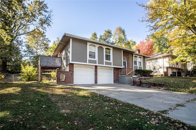 bi-level home with a front yard and a garage