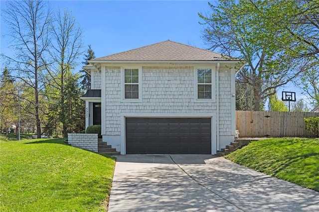 view of front of house featuring a front yard and a garage