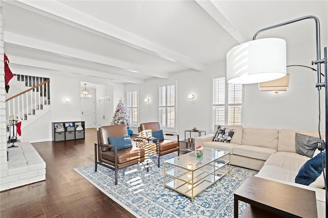 living room with beam ceiling and dark hardwood / wood-style flooring