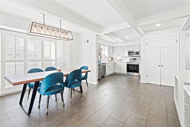 dining area featuring beamed ceiling and coffered ceiling