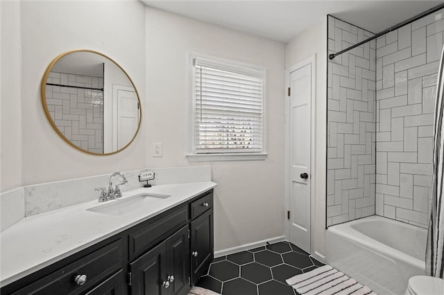 bathroom featuring tile patterned flooring, vanity, and tiled shower / bath