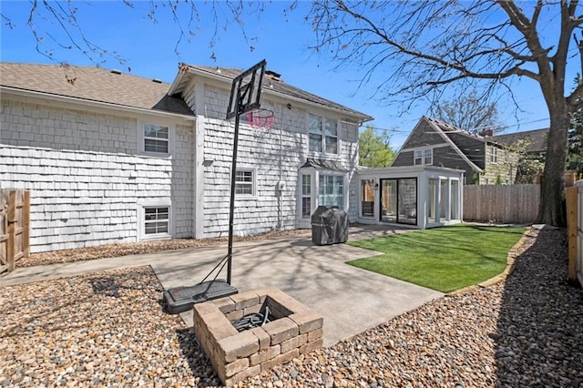 back of house with a fire pit and a patio area