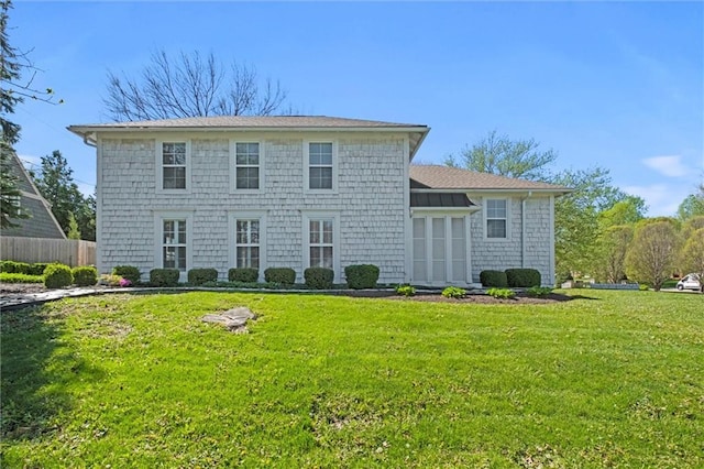 back of property featuring a lawn