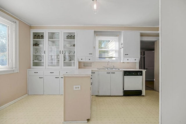 kitchen with a wealth of natural light, sink, dishwasher, and white cabinetry