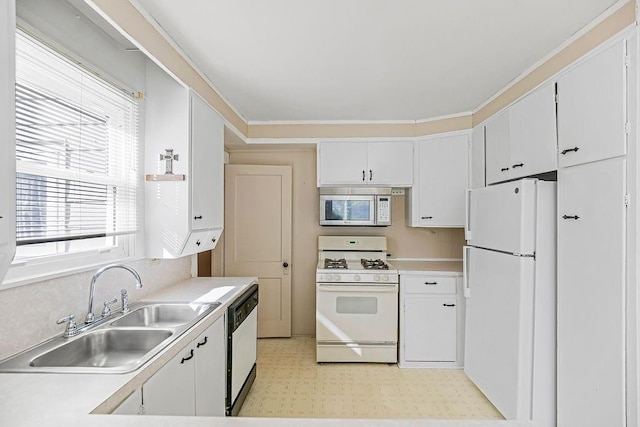 kitchen with sink, white cabinets, and white appliances