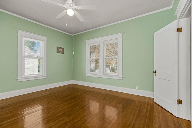 empty room with ornamental molding, wood-type flooring, and ceiling fan