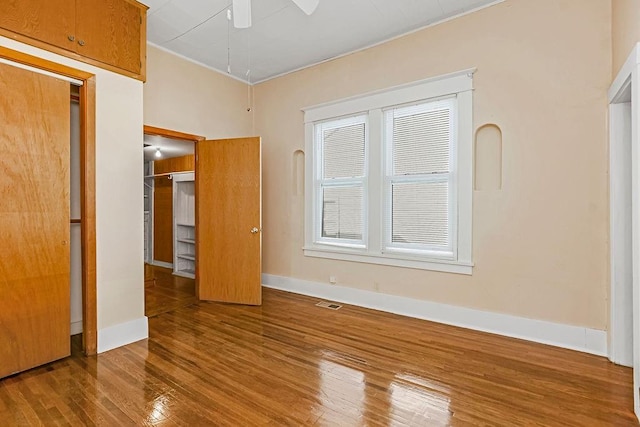 unfurnished bedroom featuring hardwood / wood-style floors and ceiling fan