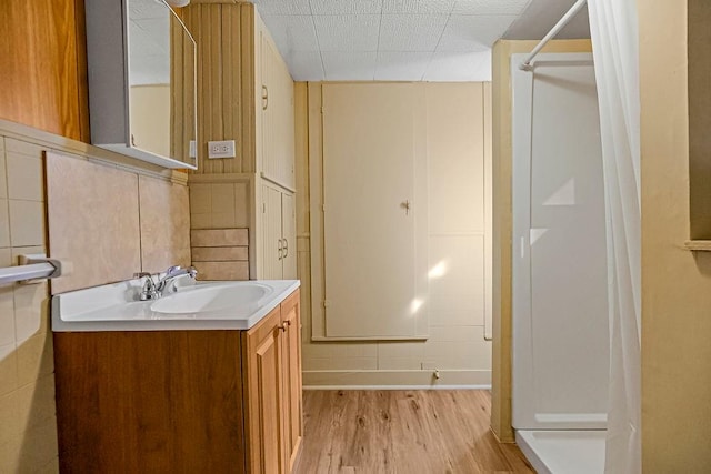 bathroom with vanity, curtained shower, and hardwood / wood-style floors