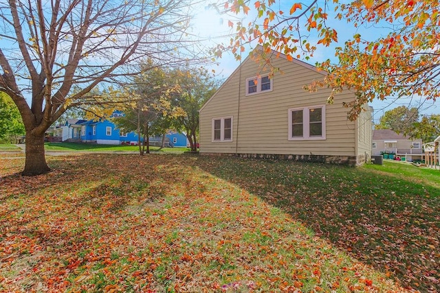 view of side of home with a yard and cooling unit