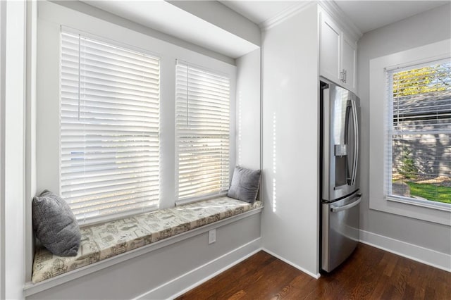 kitchen featuring stainless steel fridge, white cabinets, dark wood-type flooring, and a wealth of natural light