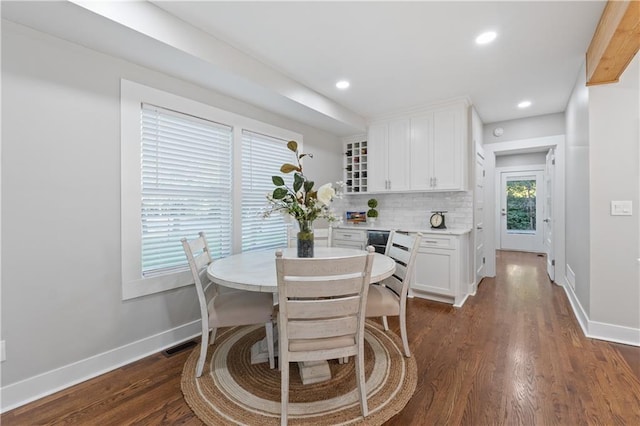 dining space with dark hardwood / wood-style flooring