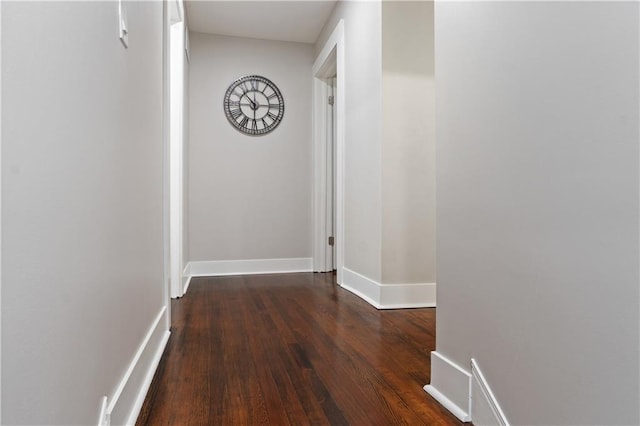 corridor with dark hardwood / wood-style flooring