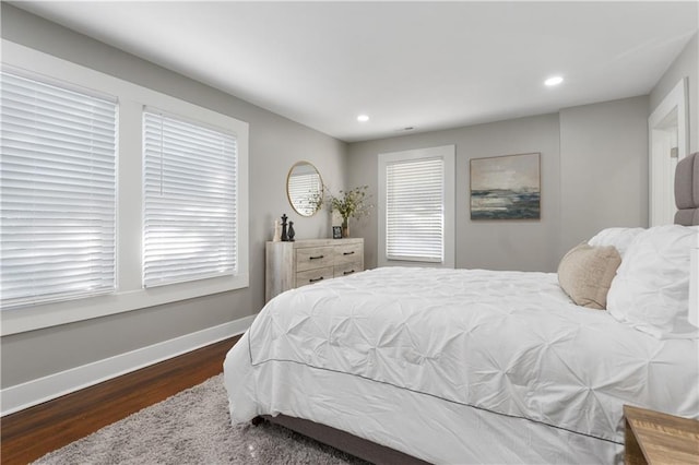 bedroom with dark hardwood / wood-style flooring