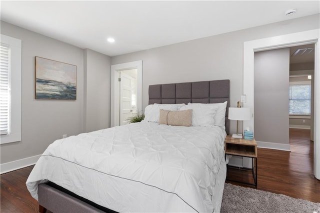 bedroom with dark hardwood / wood-style flooring