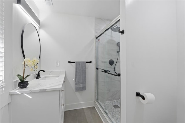 bathroom with vanity and a shower with shower door