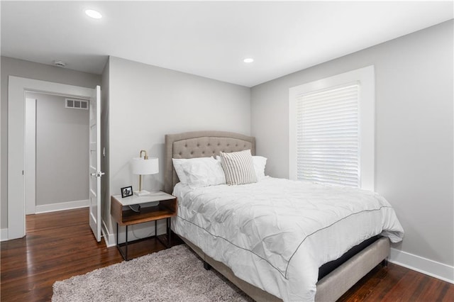 bedroom with dark wood-type flooring