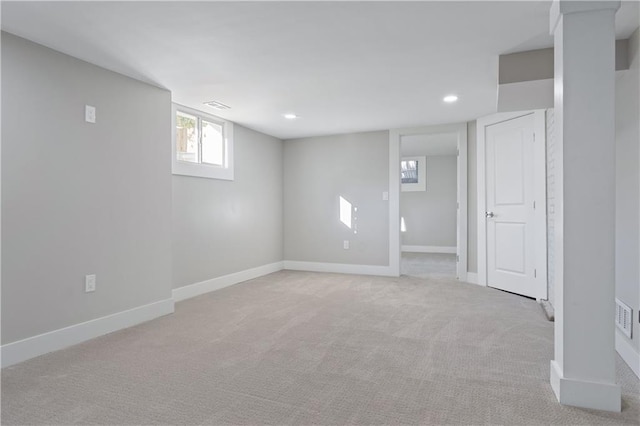 basement featuring light colored carpet