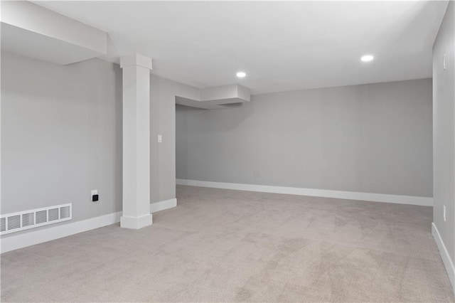 basement featuring light colored carpet