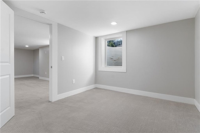 spare room featuring light colored carpet