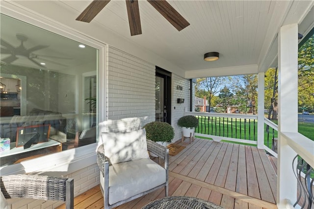 wooden terrace featuring a porch and ceiling fan