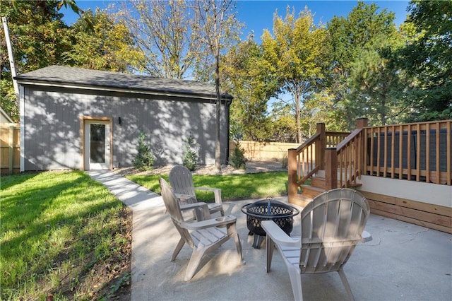 view of patio / terrace featuring an outdoor fire pit and a deck