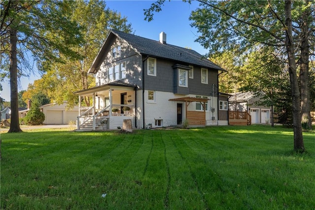 back of house featuring a yard and covered porch