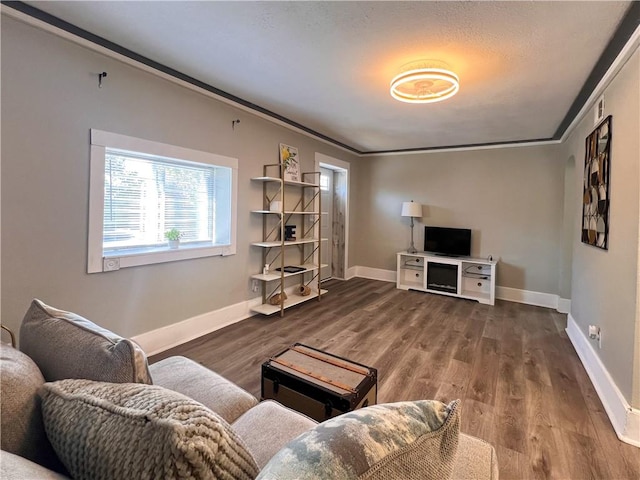 living room featuring crown molding and dark hardwood / wood-style floors