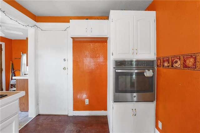 kitchen with oven and white cabinetry