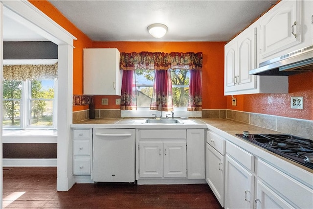 kitchen with sink, white dishwasher, dark hardwood / wood-style flooring, white cabinetry, and black gas stovetop