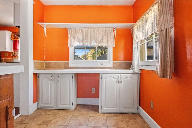 kitchen featuring white cabinetry and light tile patterned flooring