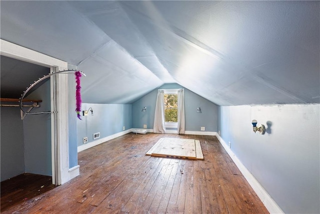 bonus room featuring dark hardwood / wood-style floors and vaulted ceiling