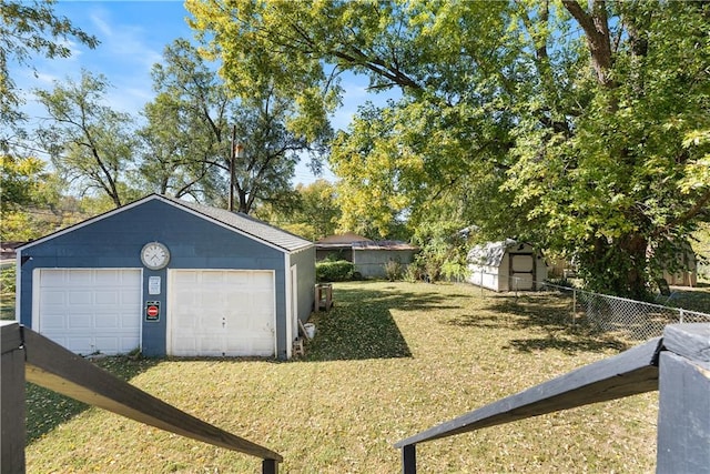 view of yard featuring an outbuilding and a garage