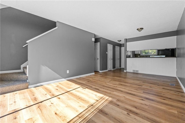 unfurnished living room with hardwood / wood-style flooring