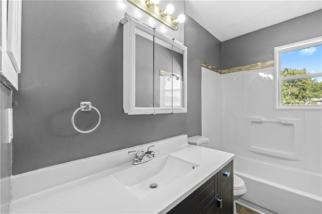 full bathroom featuring vanity, toilet, shower / tub combination, and a textured ceiling