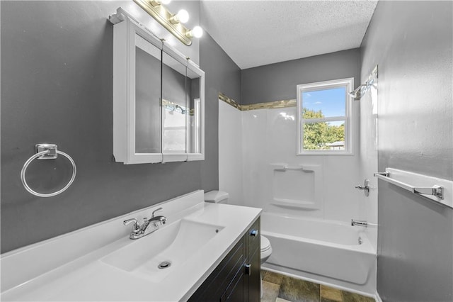 full bathroom featuring vanity, shower / bathing tub combination, a textured ceiling, and toilet