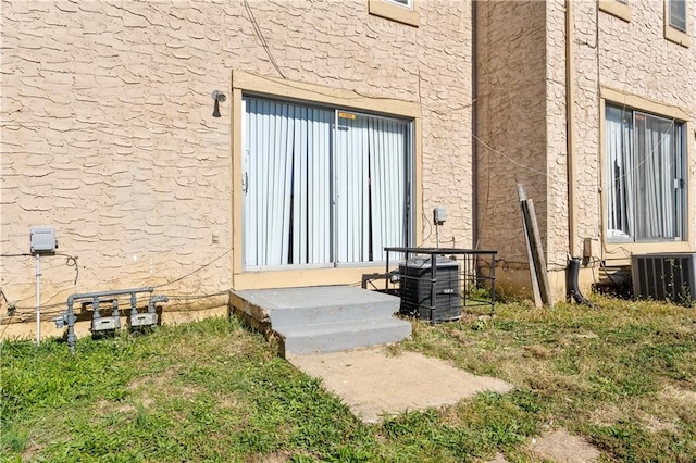 doorway to property featuring central air condition unit