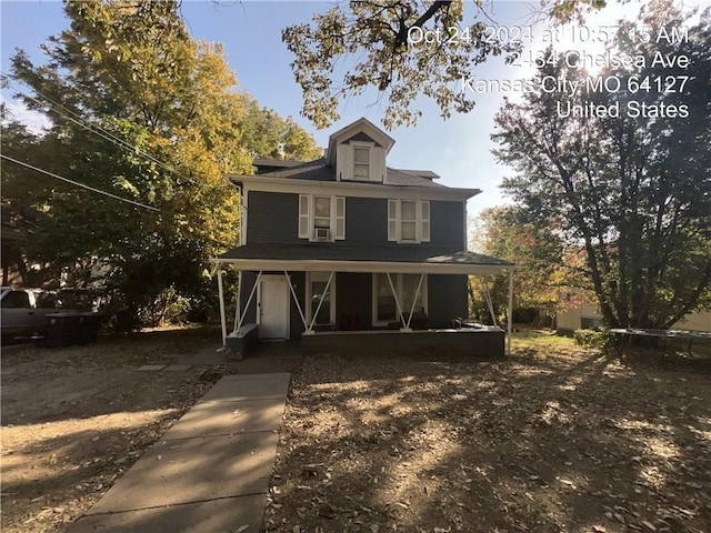 view of front of property with a porch and cooling unit