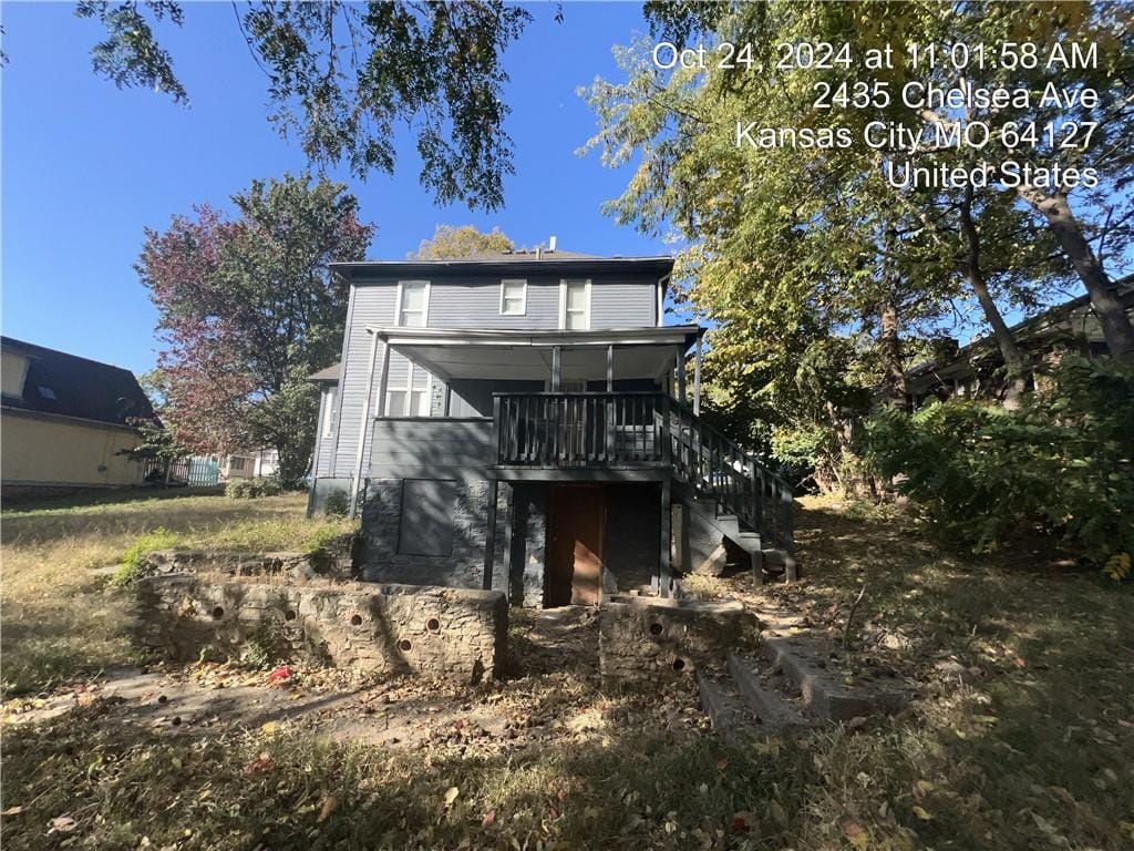 back of house featuring a wooden deck