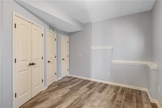 unfurnished room with hardwood / wood-style flooring