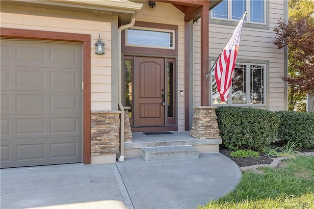 view of exterior entry with a garage