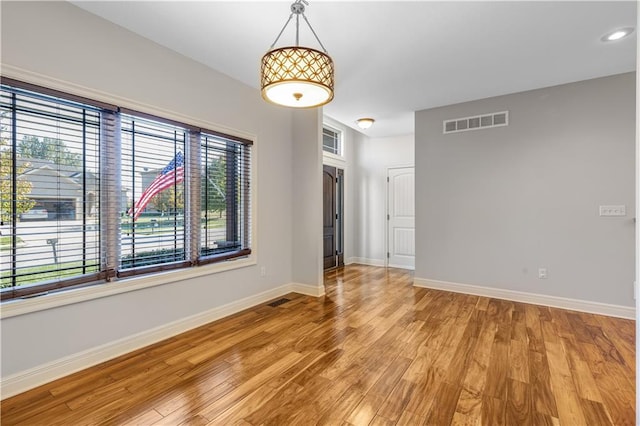 unfurnished room featuring hardwood / wood-style floors