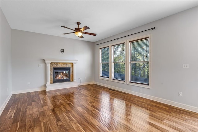 unfurnished living room featuring hardwood / wood-style floors and ceiling fan