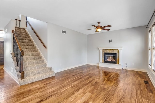 unfurnished living room with ceiling fan and wood-type flooring