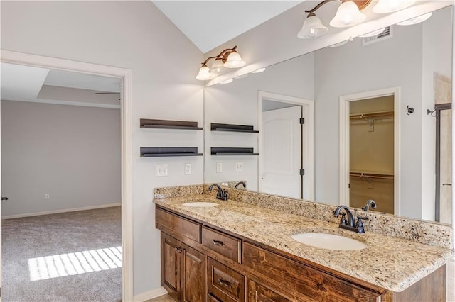 bathroom featuring vanity and vaulted ceiling