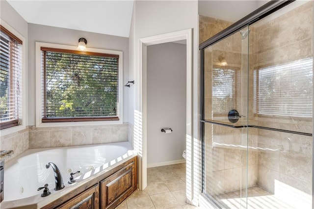 bathroom featuring tile patterned floors, plus walk in shower, and toilet